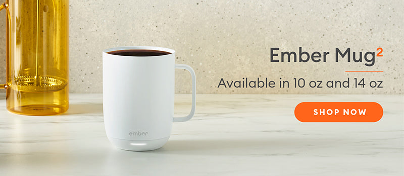 Ember Mug² in white on a marble countertop with a cream speckled wall.