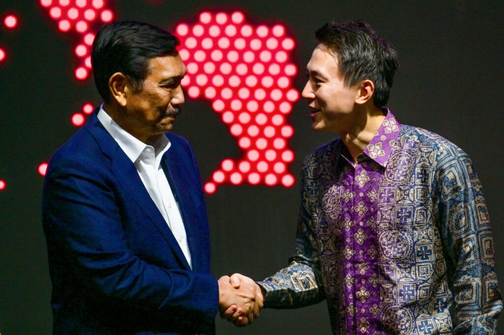 TikTok CEO Shou Zi Chew (R) shakes hands with Indonesian Coordinating Minister for Maritime Affairs and Investment Luhut Binsar Pandjaitan during the TikTok Southeast Asia Impact Forum 2023 in Jakarta, Indonesia on June 15, 2023. (Photo by BAY ISMOYO / AFP)