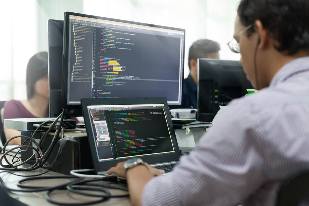 a software developer writing code on a screen